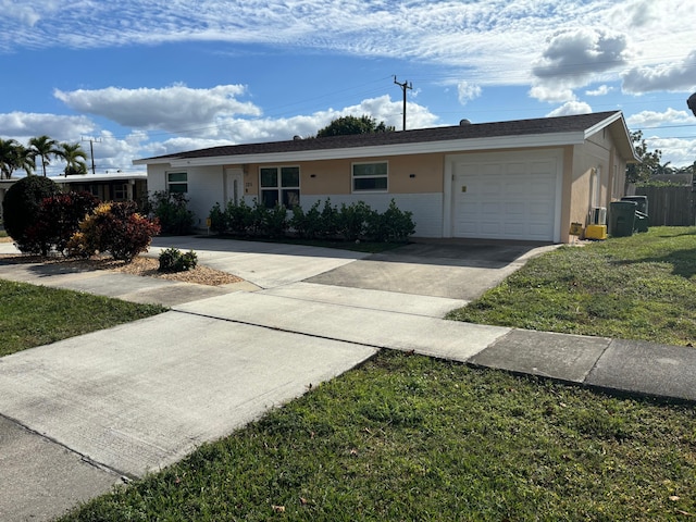 ranch-style home featuring a garage and a front lawn