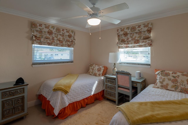 bedroom with ceiling fan, crown molding, and carpet