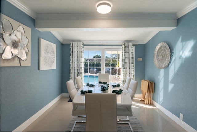 dining area with ornamental molding and tile patterned flooring