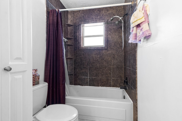 bathroom with a textured ceiling, toilet, and shower / tub combo with curtain