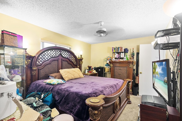 carpeted bedroom featuring ceiling fan and a textured ceiling