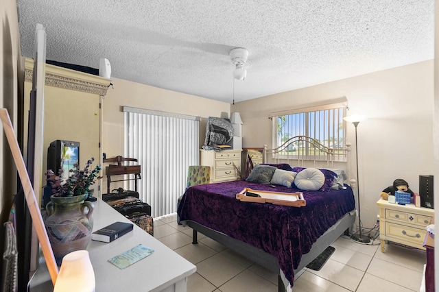 tiled bedroom featuring a textured ceiling and ceiling fan