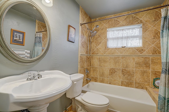 full bathroom with shower / bath combination with curtain, toilet, and sink