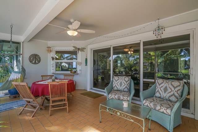 sunroom / solarium with ceiling fan and beamed ceiling