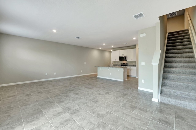 unfurnished living room featuring light tile patterned flooring