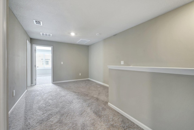 unfurnished room featuring light carpet