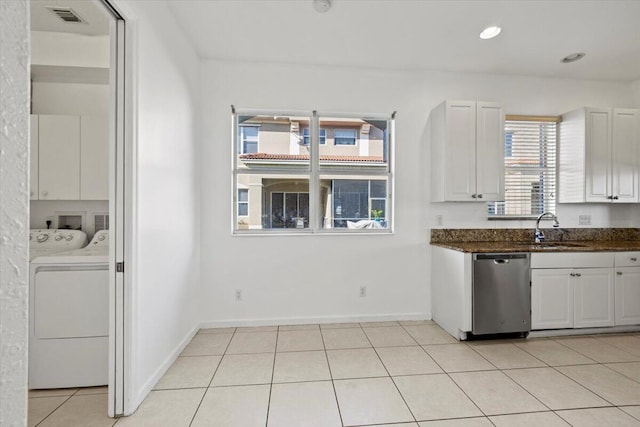 kitchen featuring dishwasher, white cabinets, washer and dryer, and sink