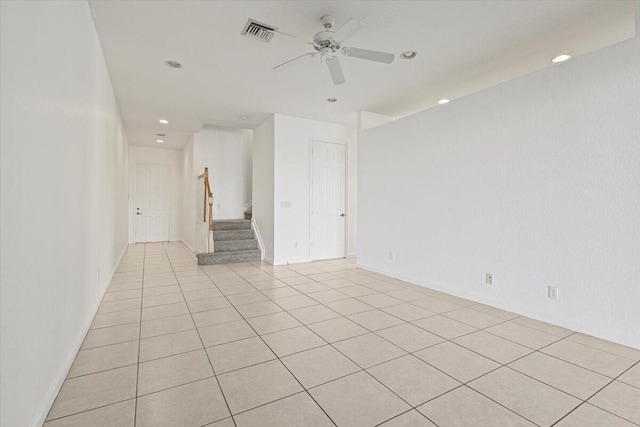 empty room with light tile patterned floors and ceiling fan