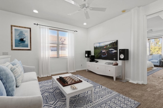 living room with ceiling fan and carpet floors