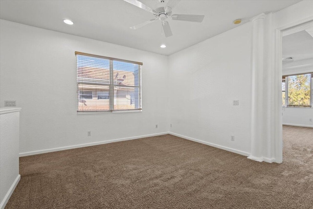 carpeted spare room with ceiling fan