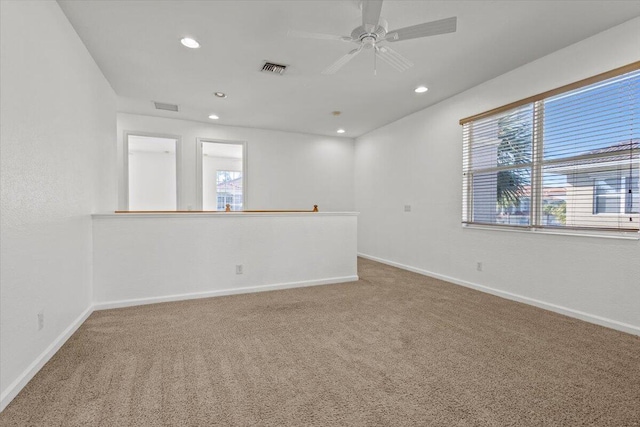 empty room with ceiling fan and carpet floors