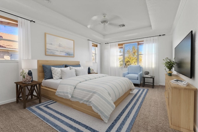 bedroom with a tray ceiling, ceiling fan, carpet flooring, and ornamental molding