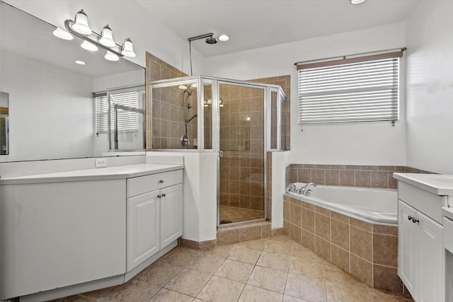 bathroom with tile patterned flooring, vanity, and independent shower and bath