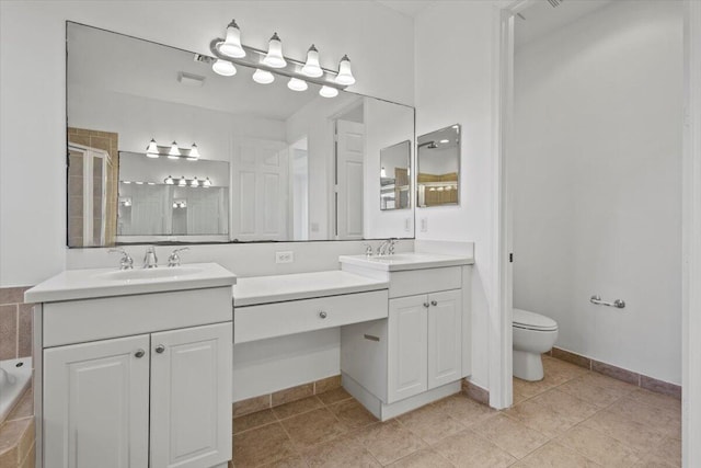 bathroom featuring tile patterned floors, vanity, toilet, and walk in shower