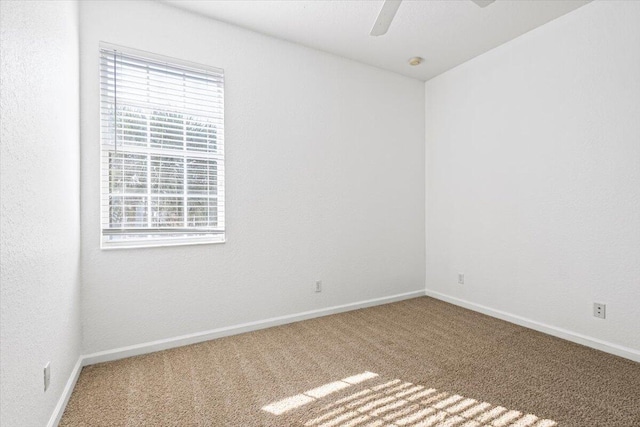 empty room featuring carpet flooring and ceiling fan