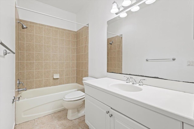 full bathroom with vanity, tile patterned flooring, tiled shower / bath, and toilet