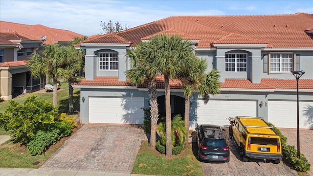 mediterranean / spanish-style home with a garage