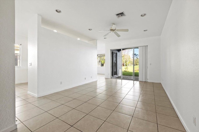 tiled empty room featuring ceiling fan