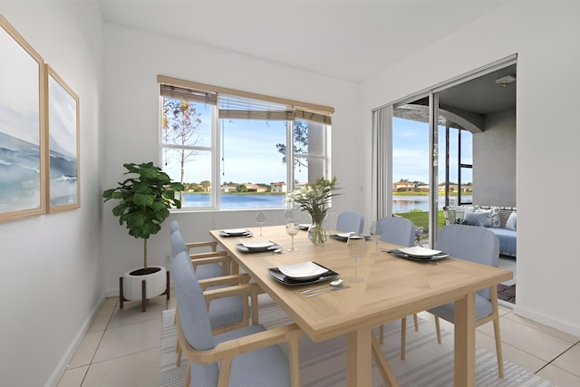 dining room featuring a water view and light tile patterned floors