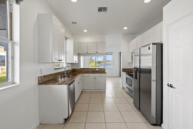 kitchen featuring sink, white cabinets, a healthy amount of sunlight, and appliances with stainless steel finishes