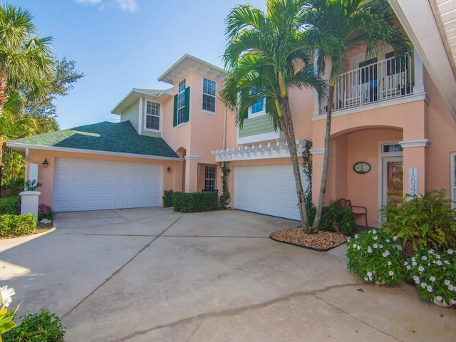 view of front of home with a garage and a balcony