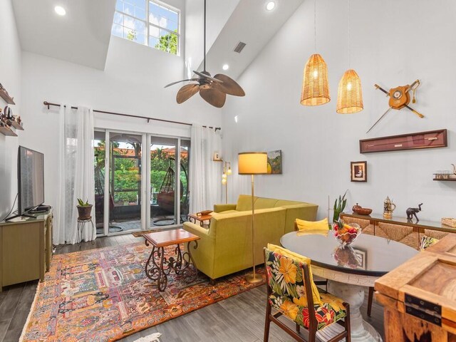 carpeted bedroom featuring ceiling fan and high vaulted ceiling