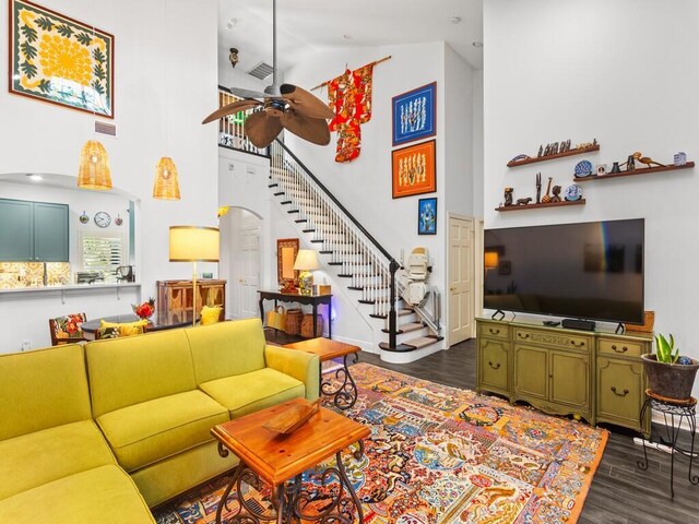 living room with ceiling fan and a textured ceiling