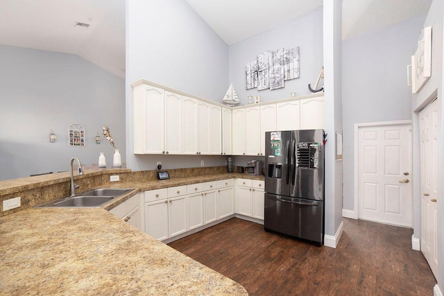 kitchen with stainless steel fridge, dark hardwood / wood-style flooring, sink, and high vaulted ceiling