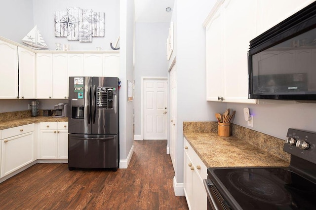 kitchen featuring white cabinets, dark hardwood / wood-style flooring, light stone counters, and black appliances