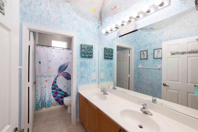 bathroom with tile patterned flooring, vanity, and toilet