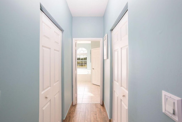 hallway with light hardwood / wood-style flooring