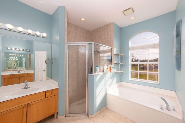 bathroom featuring tile patterned flooring, vanity, and plus walk in shower