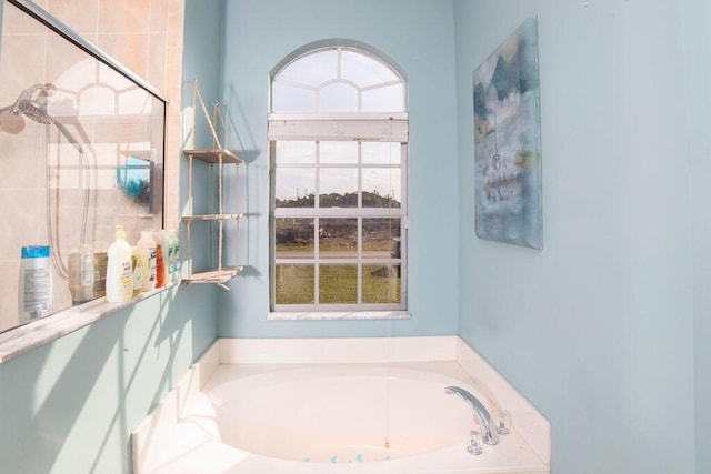 bathroom featuring shower with separate bathtub