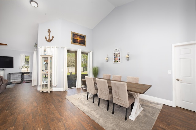 dining area with high vaulted ceiling and dark hardwood / wood-style floors