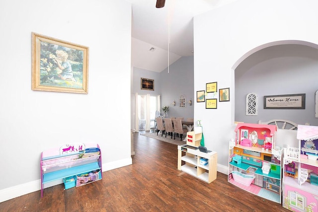 recreation room with dark hardwood / wood-style floors, ceiling fan, and lofted ceiling