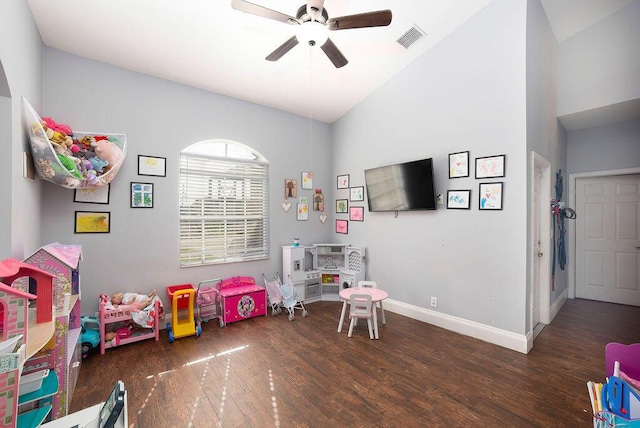 playroom featuring ceiling fan, dark wood-type flooring, and vaulted ceiling