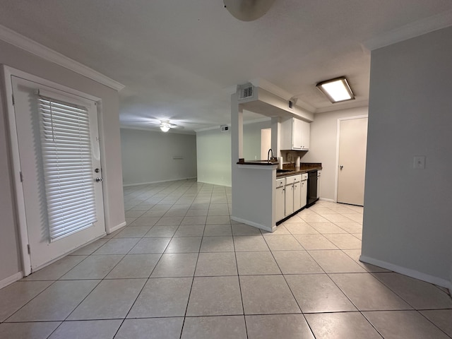 kitchen with light tile patterned floors, ornamental molding, dishwasher, and white cabinets