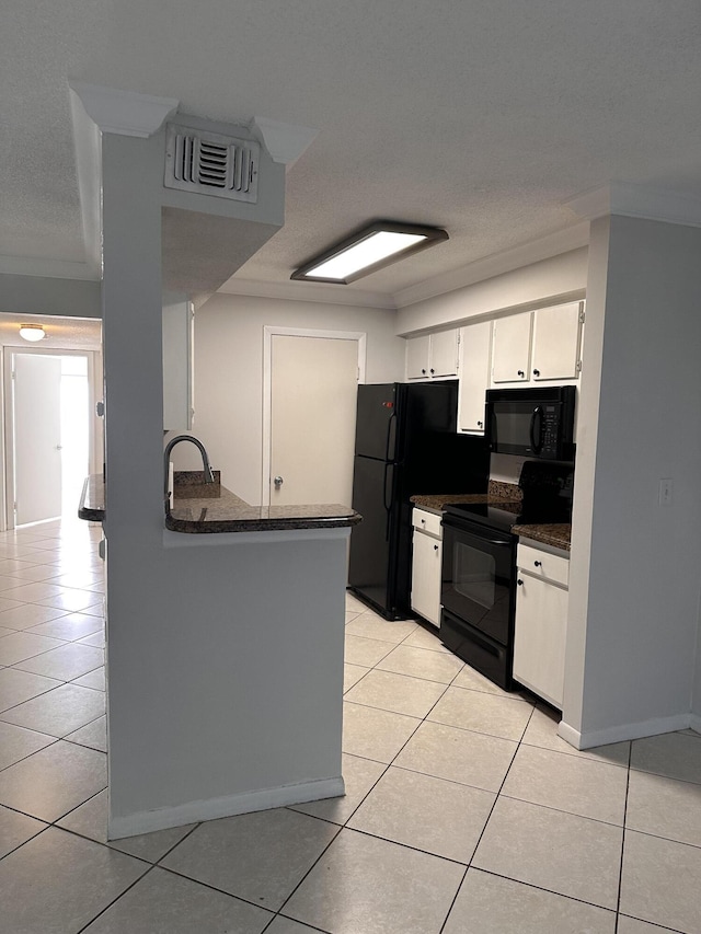 kitchen featuring light tile patterned floors, black appliances, sink, and white cabinets