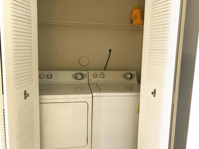 clothes washing area featuring separate washer and dryer