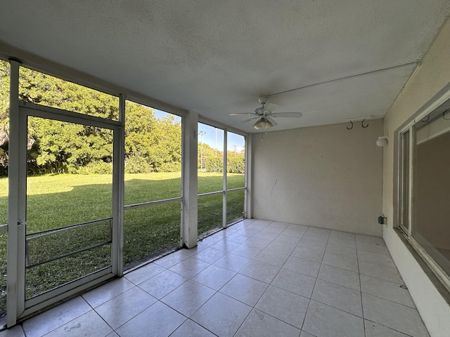 unfurnished sunroom featuring ceiling fan