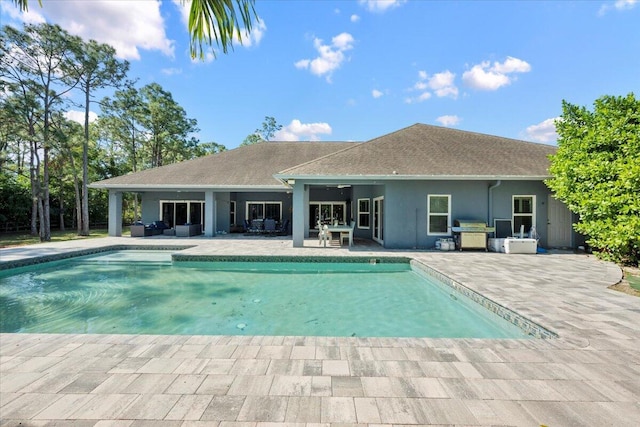 view of pool featuring a grill and a patio area