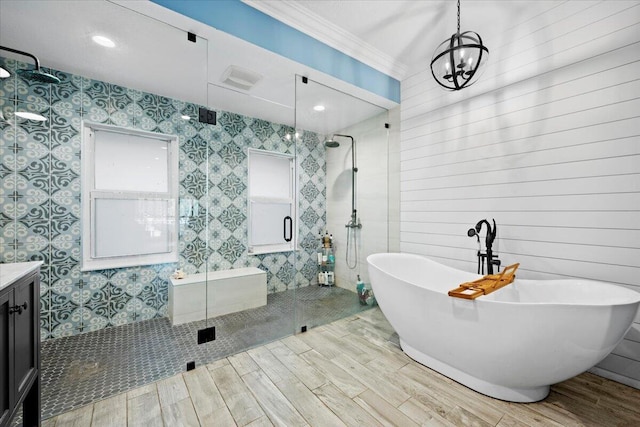 bathroom featuring ornamental molding, vanity, and separate shower and tub