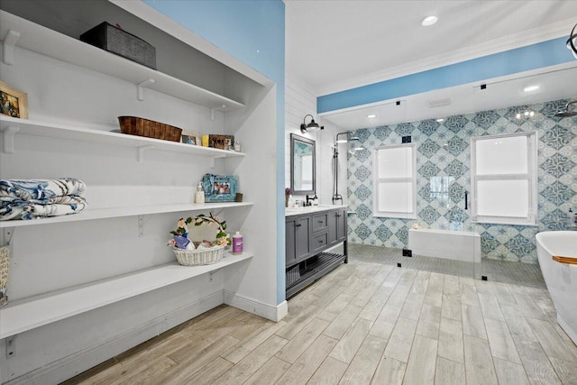 bathroom with vanity, hardwood / wood-style flooring, crown molding, and separate shower and tub