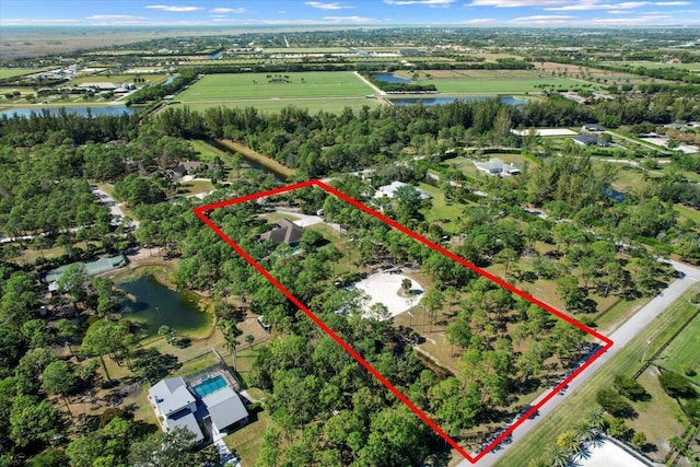 birds eye view of property with a rural view and a water view