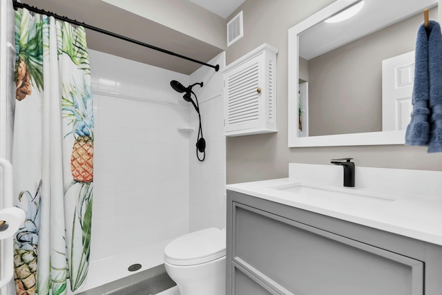 bathroom with vanity, toilet, and curtained shower