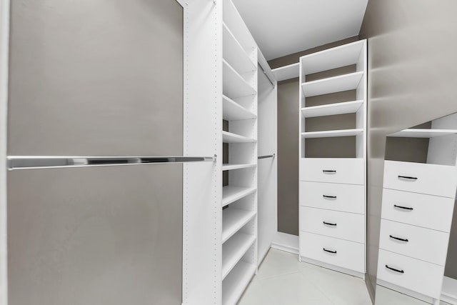 spacious closet with light tile patterned floors