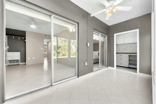 interior space featuring ceiling fan and light tile patterned flooring