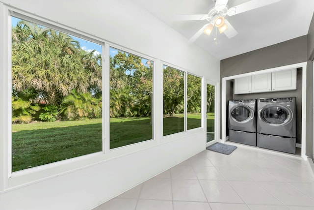 laundry room with a ceiling fan, washing machine and dryer, cabinet space, a sunroom, and light tile patterned floors