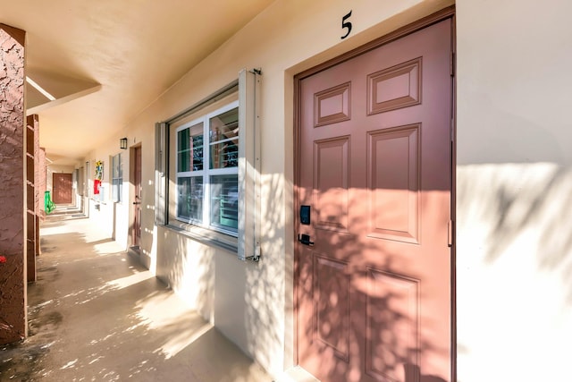 property entrance featuring stucco siding