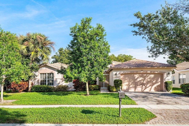 view of front of house with a garage and a front yard